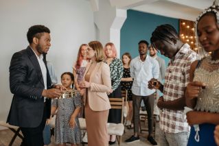 People with Communion Cups Praying in a Church